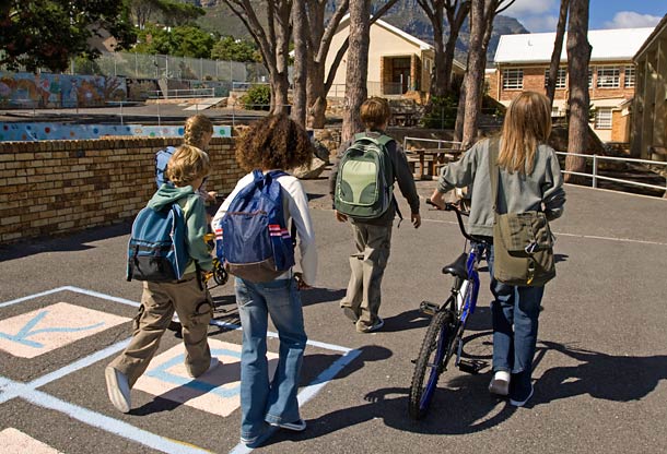 Kids walk by school