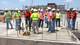 Students stand on the site of the s

chool’s state of the art auto shop.
