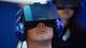 A man uses a virtual reality headset to experience virtual reality.
